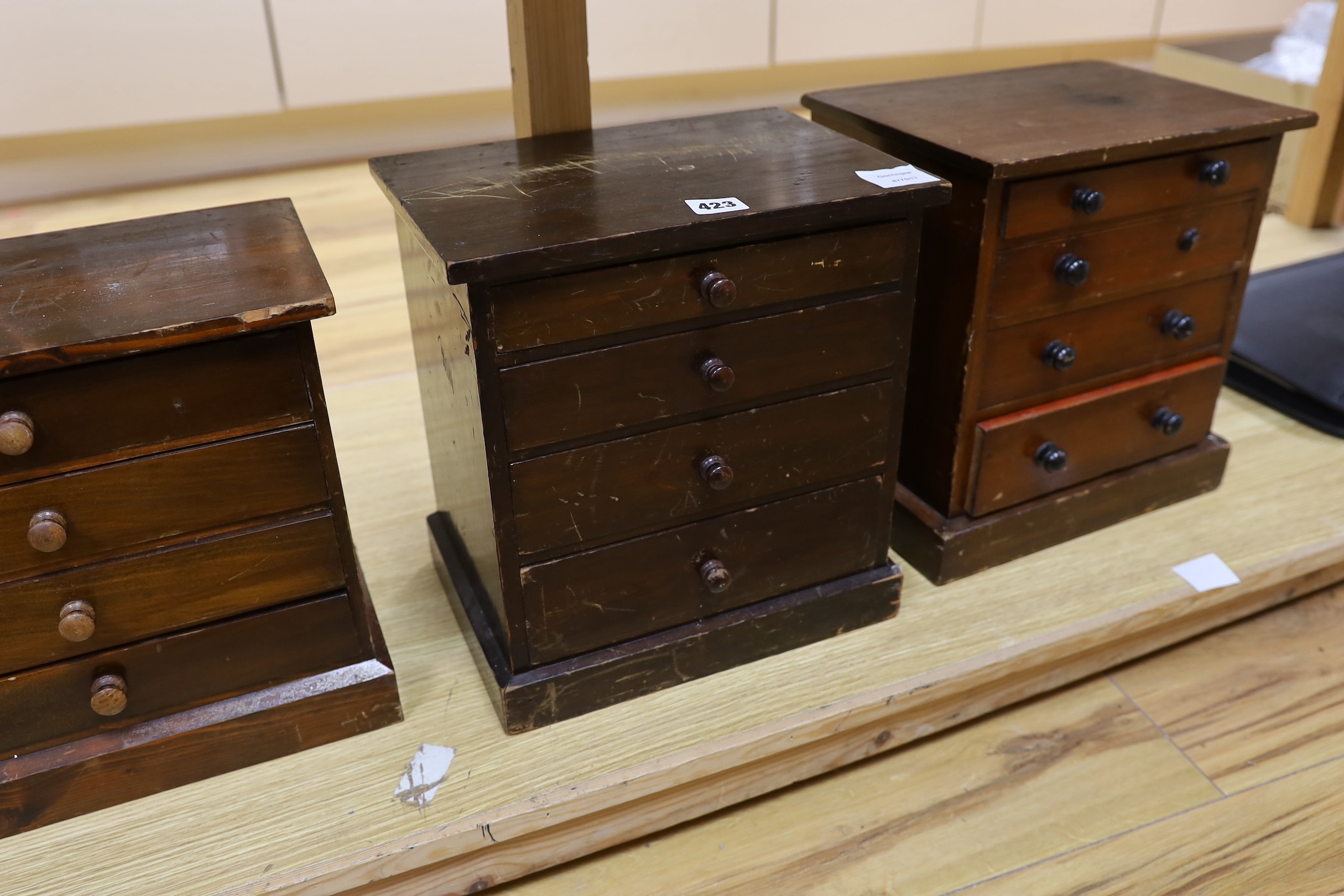 Three miniature four drawer collector's chests, tallest 33cms high